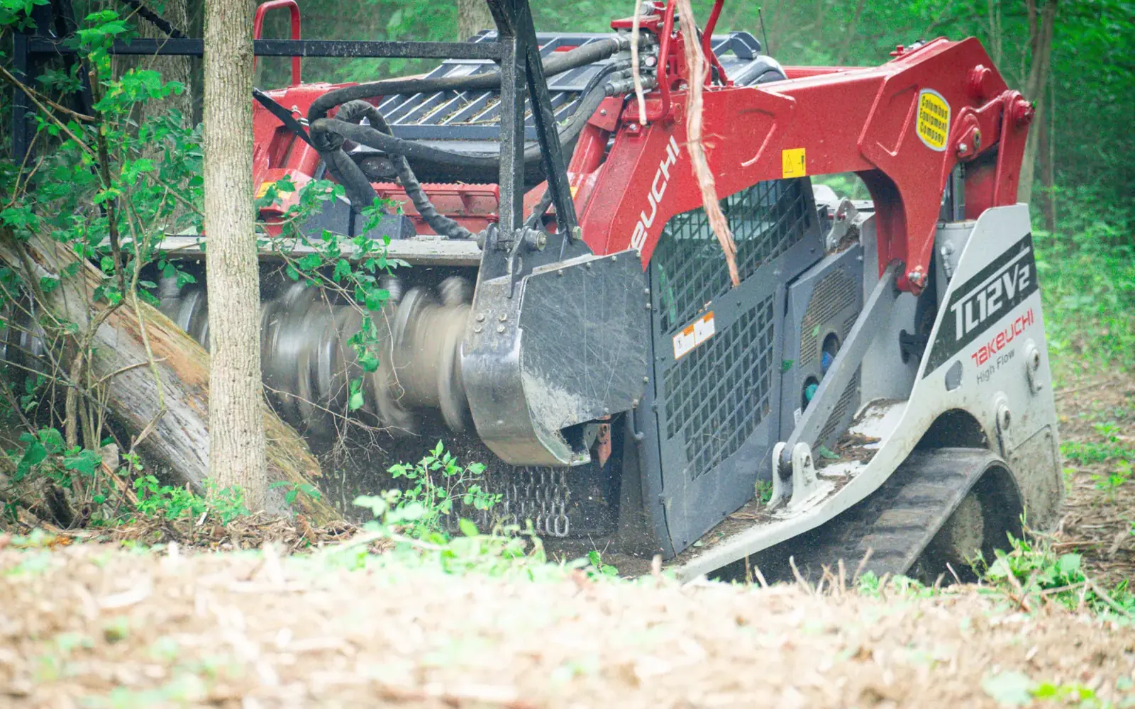 Fecon mulching head grinding a thick tangle of brush
