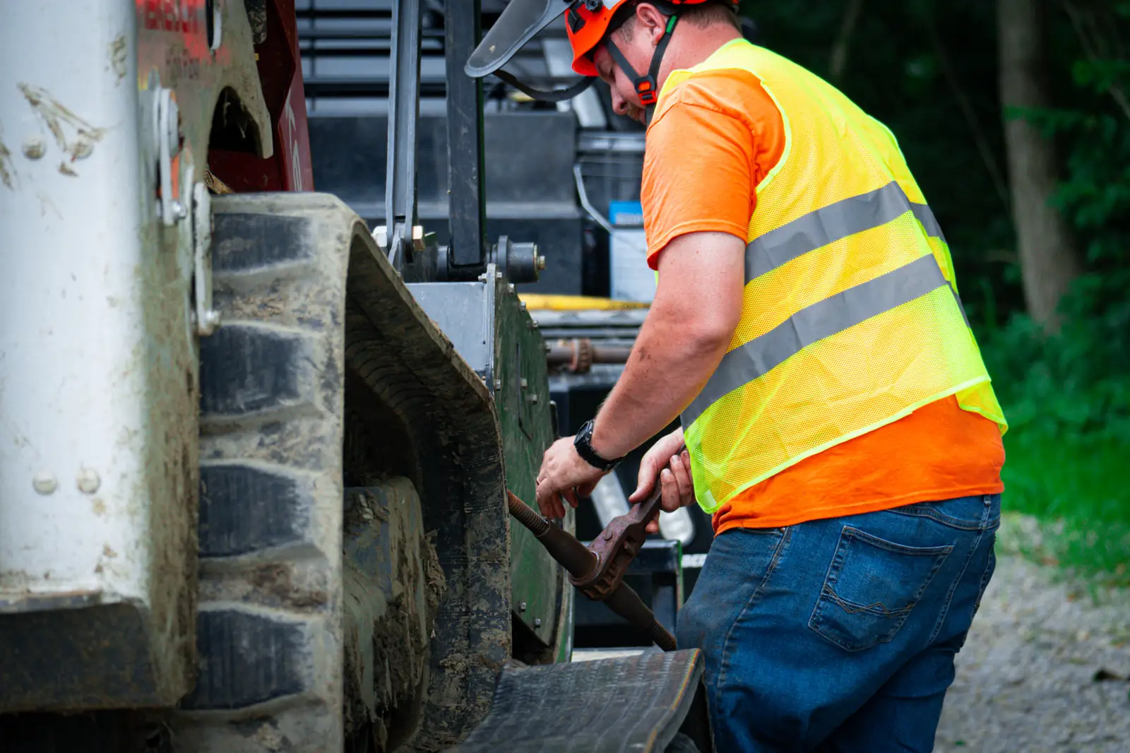 Brushworks operator in hi-vis setting up a machine for the day