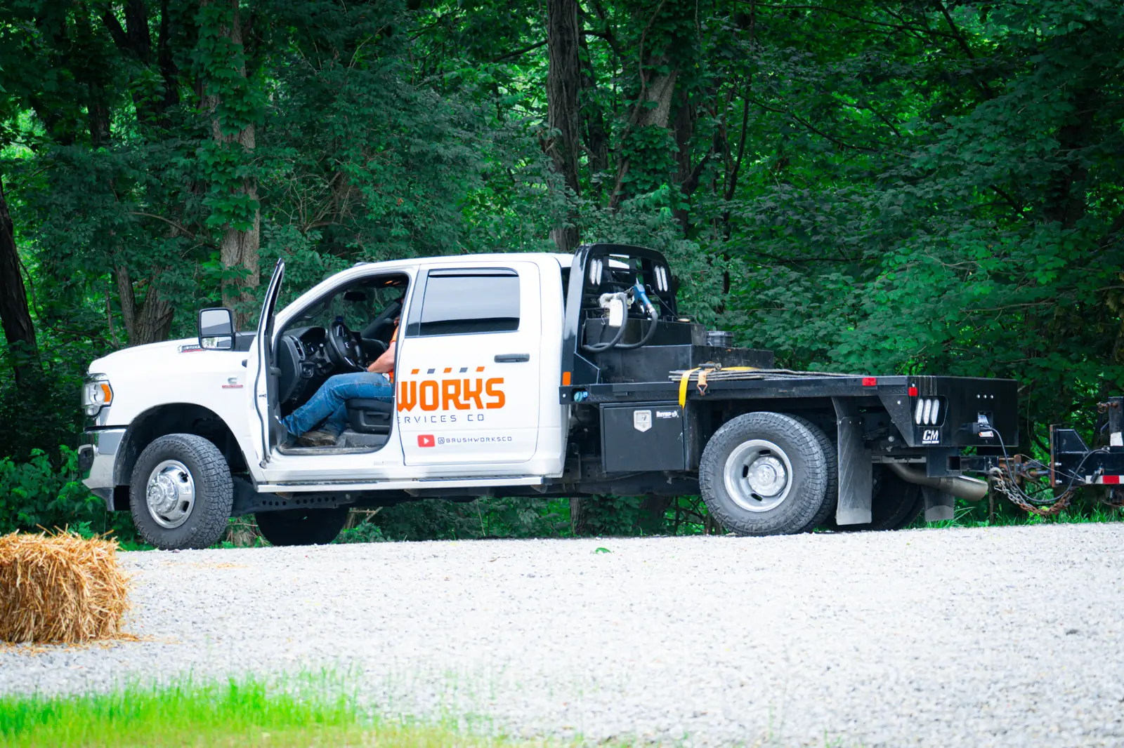 Brushworks RAM 5500 flatbed truck arriving at a job site
