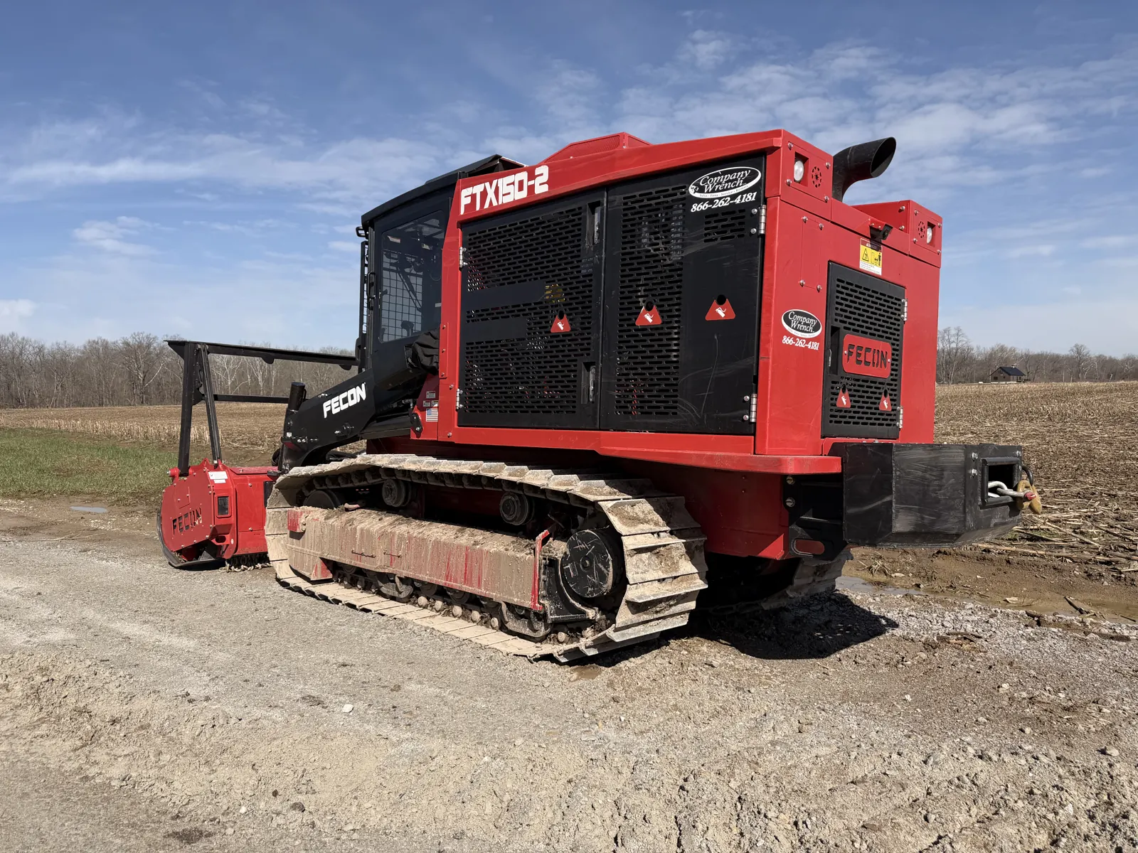 Fecon FTX150 dedicated track mulcher parked at the edge of a field