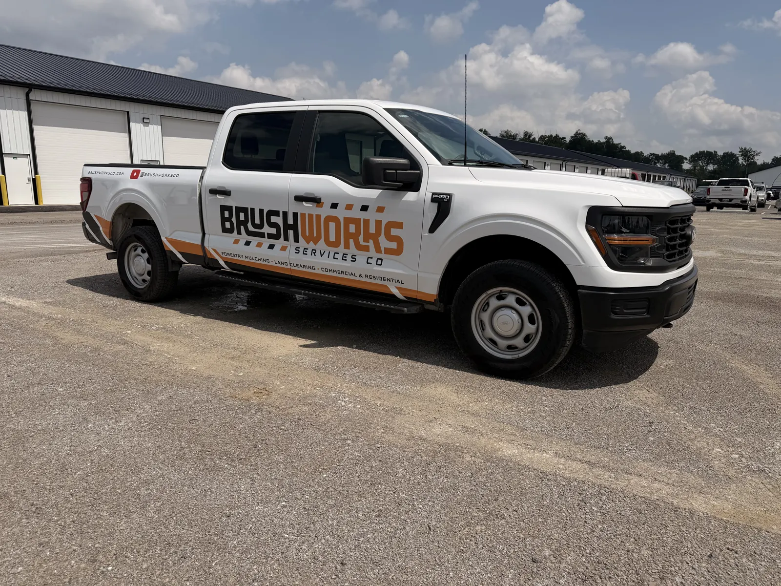 Brushworks branded pickup truck parked at the shop