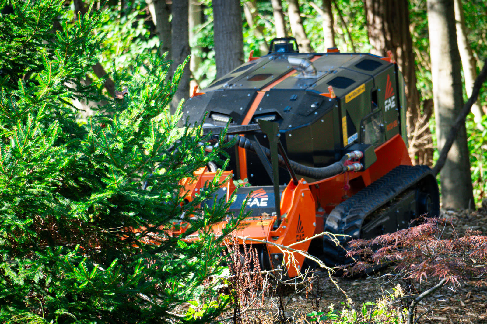 FAE RCU remote mulcher clearing brush on uneven terrain