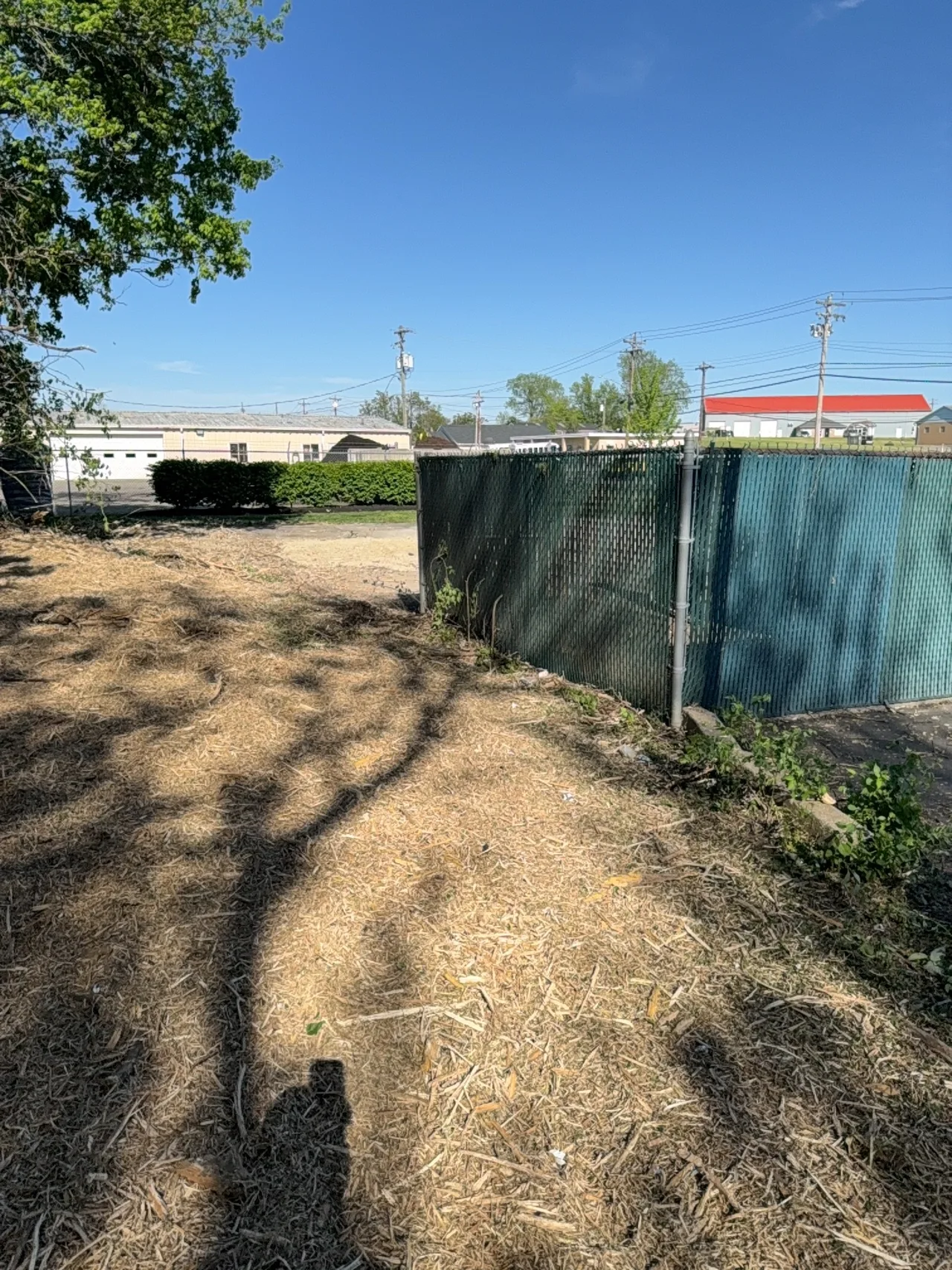Cleared and mulched ground around the same Fairfield dumpster enclosure