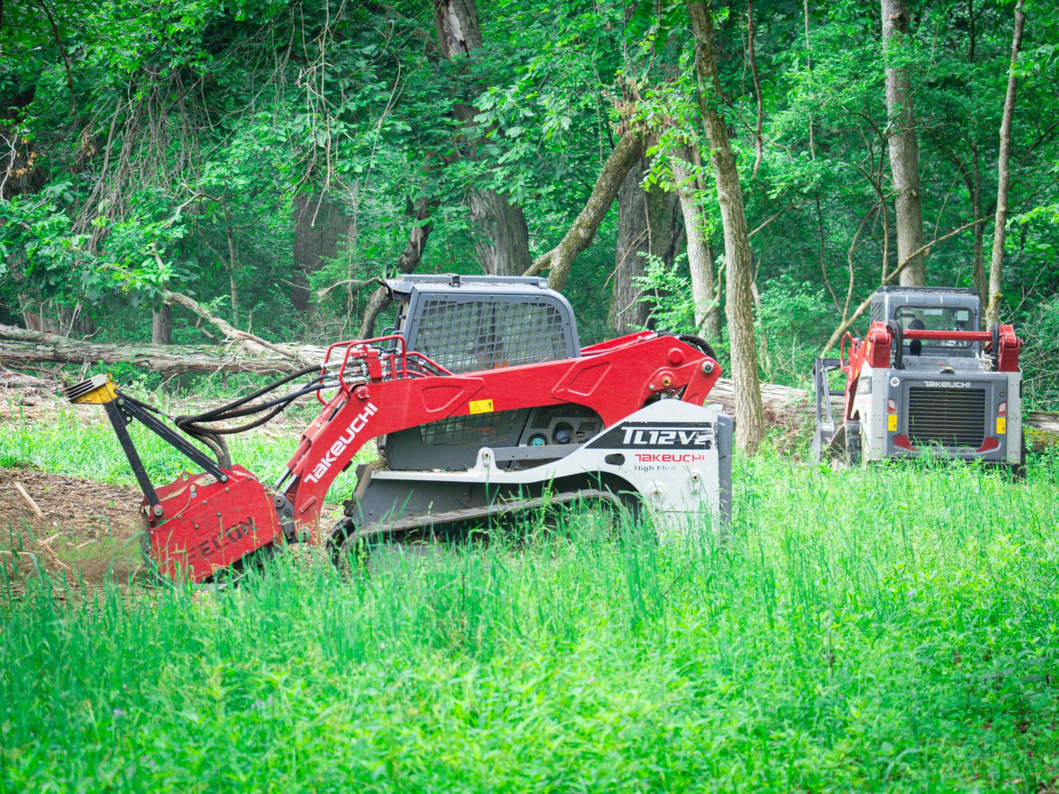 Real Takeuchi TL12 making a forestry mulching pass along a field edge