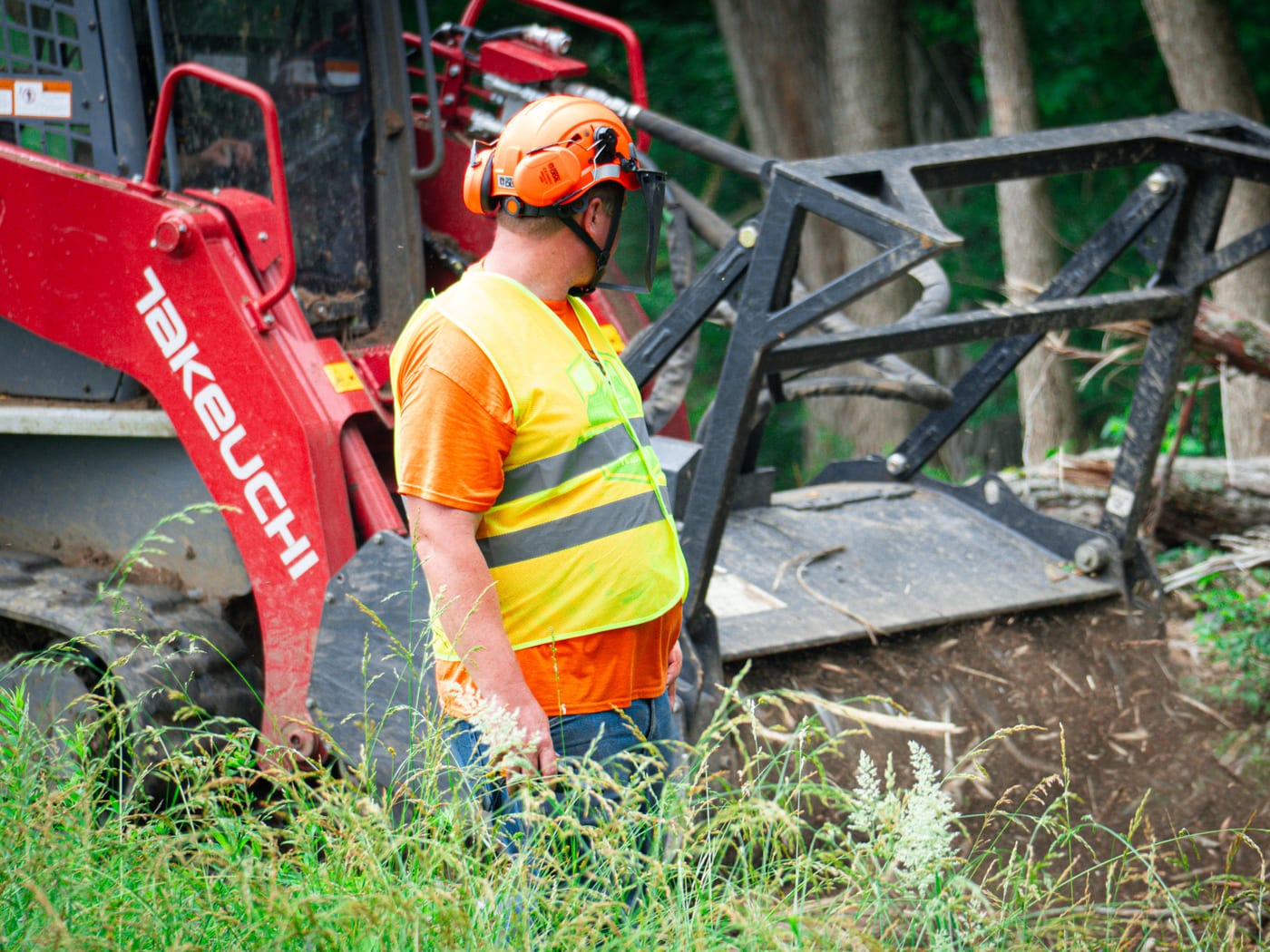 Brushworks team member working close to the mulching attachment