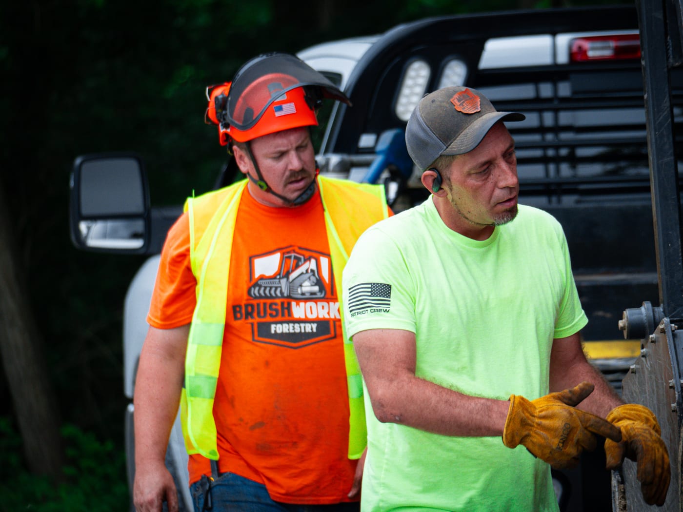 Brushworks crew walking around equipment during jobsite prep